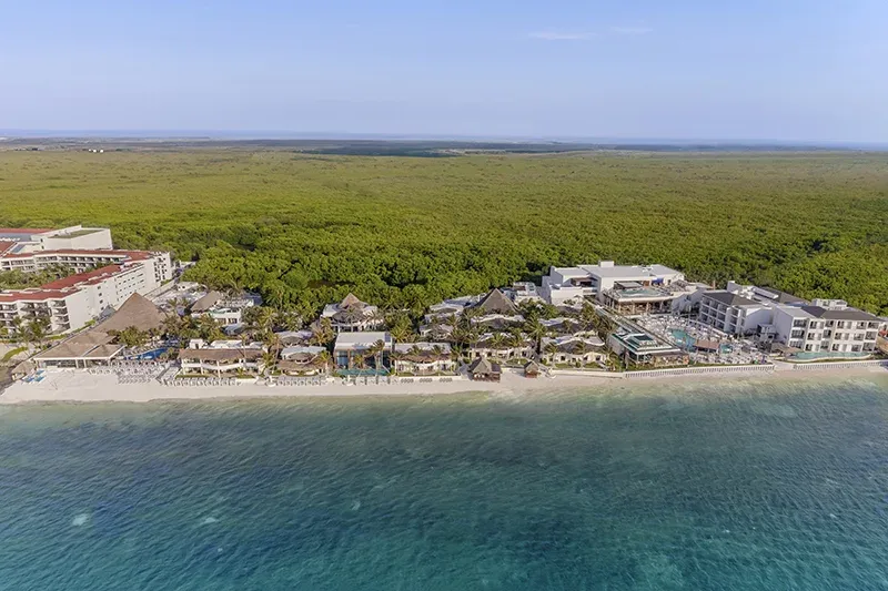Aerial view of Desire Riviera Maya Resort between the Caribbean Sea and mangroves