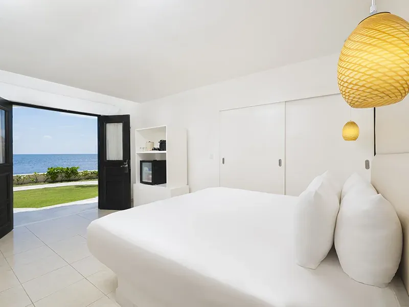 Deluxe Ocean View room opening onto a terrace beside the Caribbean