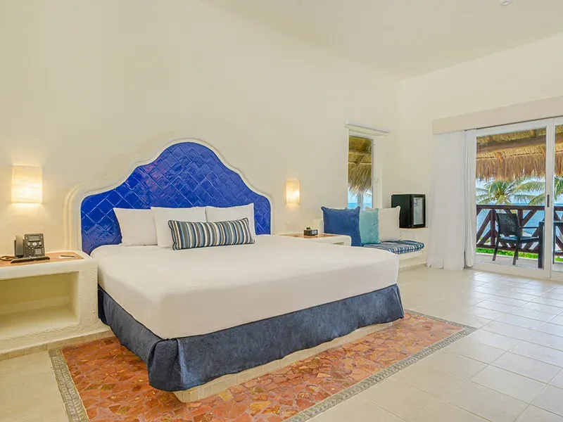 Junior Suite with blue-tiled headboard and private terrace doors
