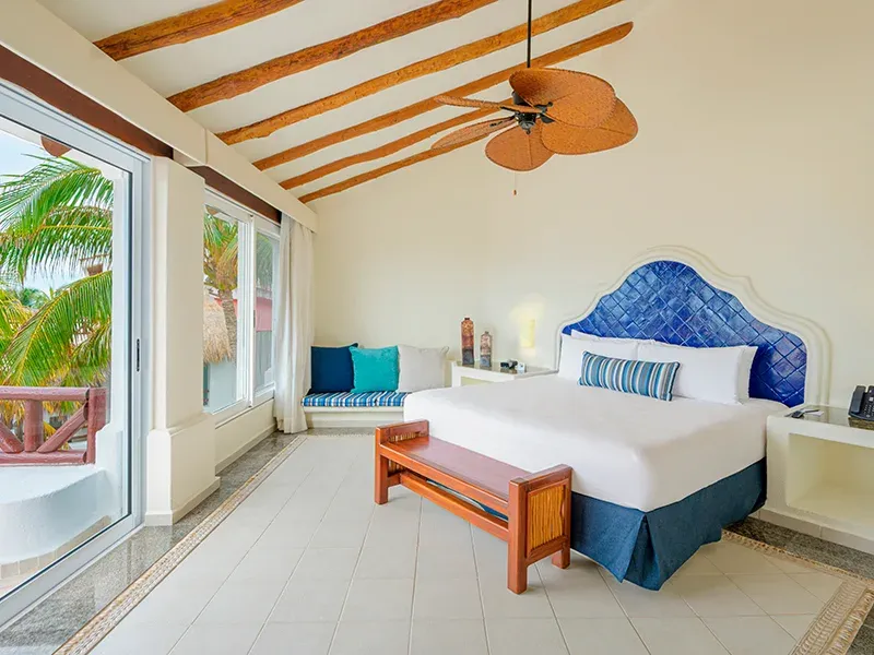 Penthouse Passion Suite bedroom with vaulted wood-beam ceiling