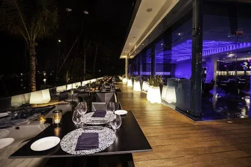 Outdoor dining terrace at Sea Flirt restaurant after dark