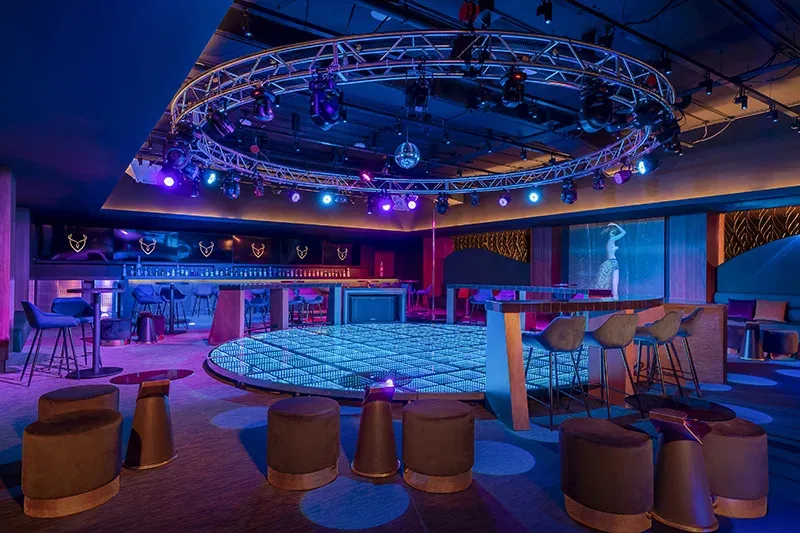 Y Nightclub with illuminated dance floor and blue and purple lighting